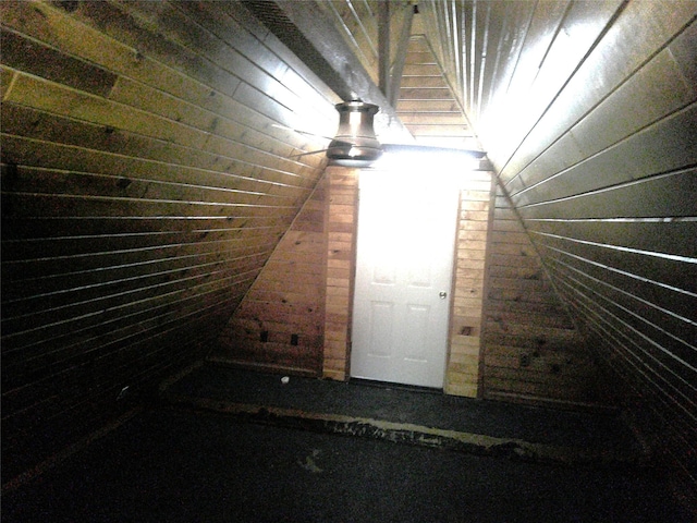 999 Roberts Cut Off Rd, Bowie, TX 76230 - stairway featuring vaulted ceiling and wood walls