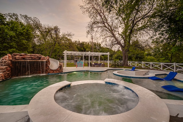 1015 S Lowrance Rd, Pecan Hill, TX 75154 - view of swimming pool featuring a pergola, a pool with connected hot tub, view of scattered trees, a water slide, and a patio area