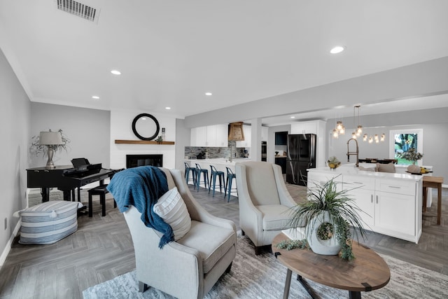 1015 S Lowrance Rd, Pecan Hill, TX 75154 - living room featuring recessed lighting, baseboards, a glass covered fireplace, and a chandelier
