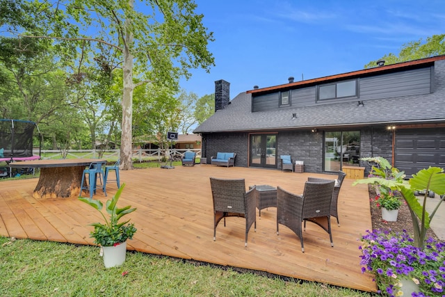 1015 S Lowrance Rd, Pecan Hill, TX 75154 - wooden deck featuring a trampoline, outdoor dining space, and outdoor lounge area