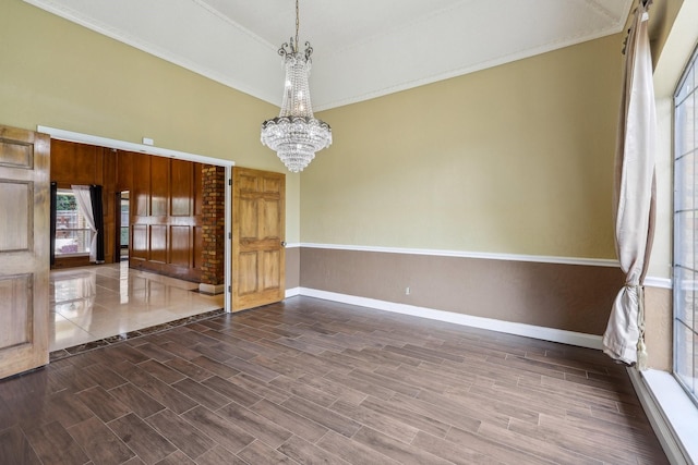 906 Greenbriar Ln, Duncanville, TX 75137 - spare room featuring a chandelier, baseboards, dark wood-type flooring, and ornamental molding