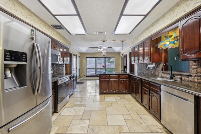 906 Greenbriar Ln, Duncanville, TX 75137 - kitchen with stainless steel appliances, a sink, a peninsula, decorative backsplash, and ceiling fan