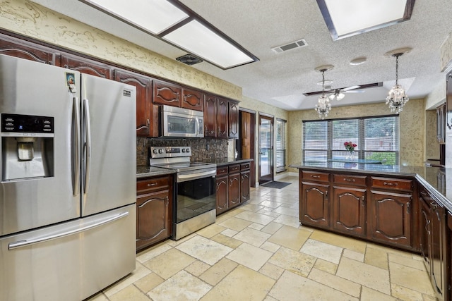 906 Greenbriar Ln, Duncanville, TX 75137 - kitchen featuring appliances with stainless steel finishes, dark countertops, backsplash, stone tile flooring, and a chandelier