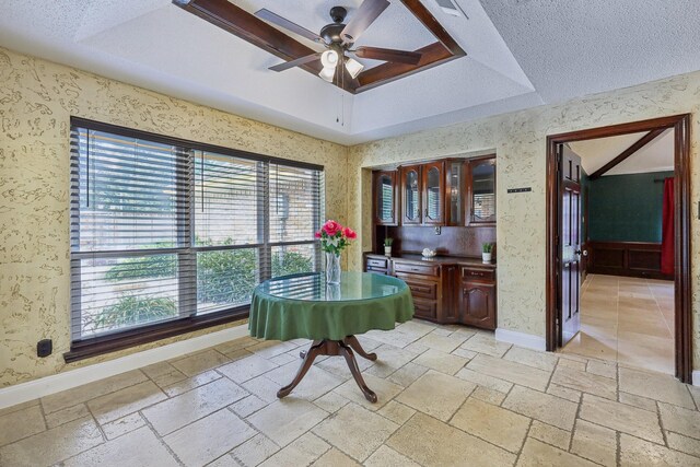 906 Greenbriar Ln, Duncanville, TX 75137 - dining area with a raised ceiling, a ceiling fan, baseboards, and stone tile floors