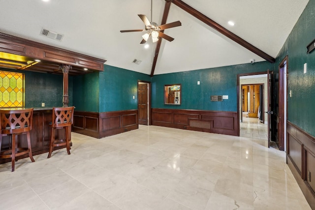 906 Greenbriar Ln, Duncanville, TX 75137 - indoor dry bar featuring a decorative wall, wainscoting, beam ceiling, a ceiling fan, and high vaulted ceiling