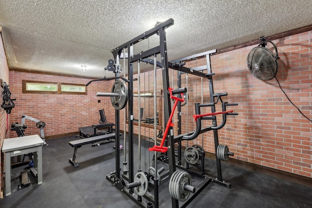 906 Greenbriar Ln, Duncanville, TX 75137 - exercise area featuring a textured ceiling and brick wall