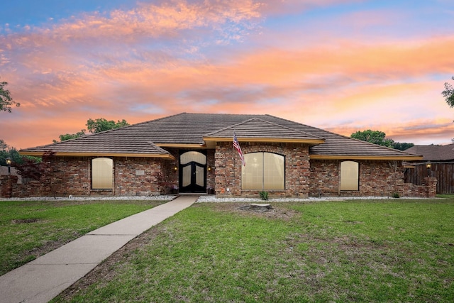 906 Greenbriar Ln, Duncanville, TX 75137 - view of front of home featuring a front yard, brick siding, and a tile roof