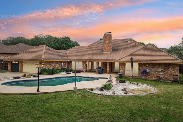 906 Greenbriar Ln, Duncanville, TX 75137 - rear view of property with brick siding, a yard, a chimney, and a tiled roof
