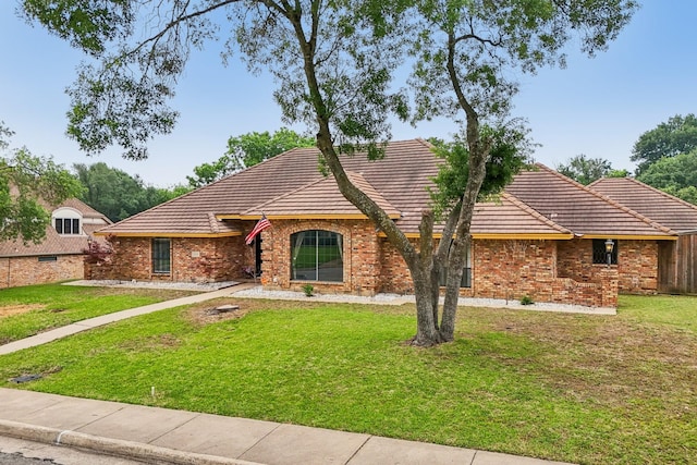906 Greenbriar Ln, Duncanville, TX 75137 - view of front of house with a tile roof, a front lawn, and brick siding