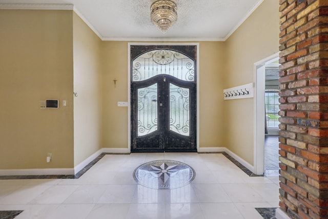 906 Greenbriar Ln, Duncanville, TX 75137 - entryway featuring french doors, a textured ceiling, ornamental molding, tile patterned floors, and baseboards