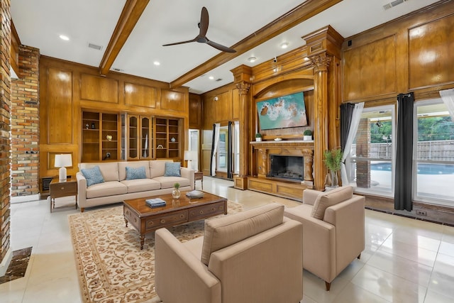 906 Greenbriar Ln, Duncanville, TX 75137 - living room with a fireplace, light tile patterned flooring, wooden walls, ceiling fan, and beam ceiling