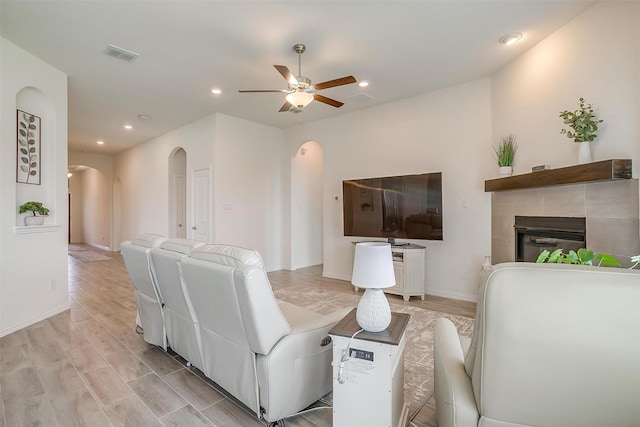 7200 Paso Verde Dr, Fort Worth, TX 76131 - living room with arched walkways, a ceiling fan, a fireplace, recessed lighting, and baseboards