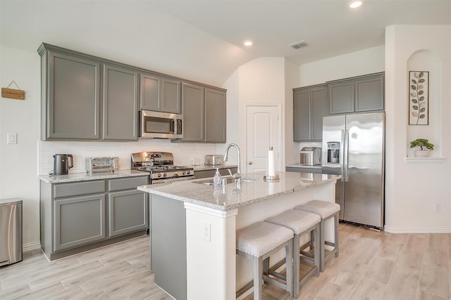 7200 Paso Verde Dr, Fort Worth, TX 76131 - kitchen with appliances with stainless steel finishes, a sink, tasteful backsplash, a center island with sink, and recessed lighting