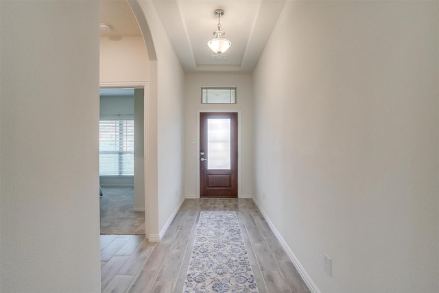7200 Paso Verde Dr, Fort Worth, TX 76131 - doorway featuring arched walkways, light wood-style flooring, and baseboards