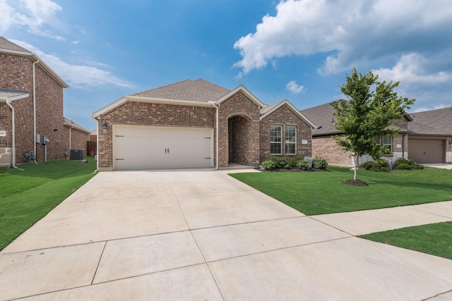 10213 Plumlee Ln, Aubrey, TX 76227 - view of front of home featuring brick siding, a garage, central AC, driveway, and a front lawn