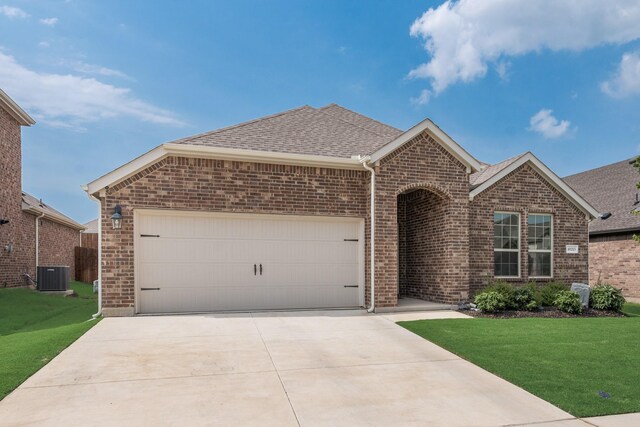10213 Plumlee Ln, Aubrey, TX 76227 - view of front of house with brick siding, a front yard, roof with shingles, central air condition unit, and driveway