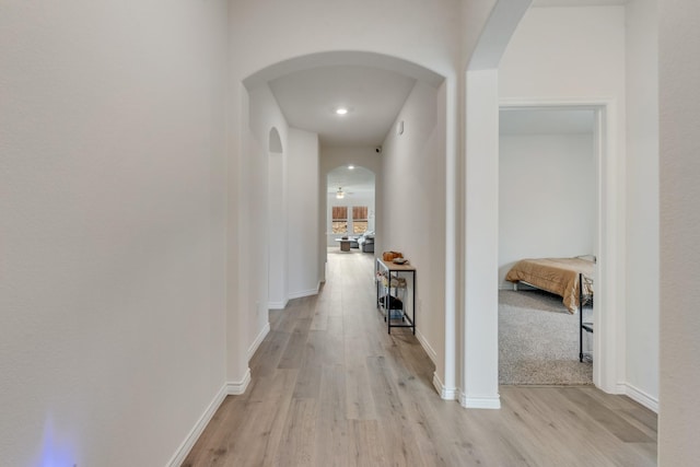 10213 Plumlee Ln, Aubrey, TX 76227 - hallway with light wood-type flooring, arched walkways, baseboards, and recessed lighting