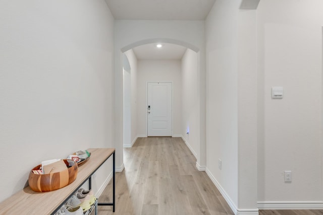 10213 Plumlee Ln, Aubrey, TX 76227 - hallway with arched walkways, light wood finished floors, and baseboards