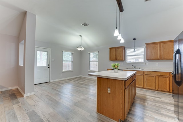 1900 Clear Creek Dr, Little Elm, TX 75068 - kitchen with a kitchen island, a sink, light countertops, brown cabinets, and lofted ceiling
