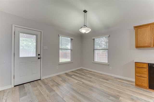1900 Clear Creek Dr, Little Elm, TX 75068 - unfurnished dining area featuring healthy amount of natural light, light wood-style flooring, and baseboards
