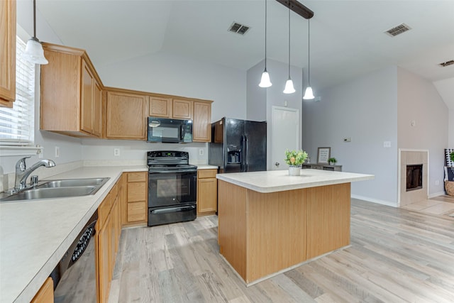 1900 Clear Creek Dr, Little Elm, TX 75068 - kitchen featuring black appliances, a sink, vaulted ceiling, light wood-style floors, and a center island