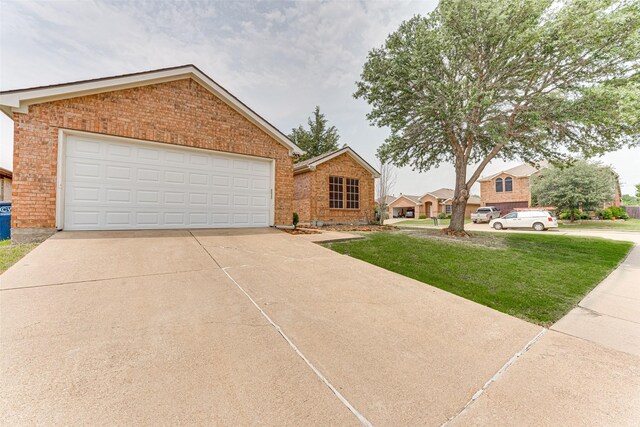 1900 Clear Creek Dr, Little Elm, TX 75068 - view of front of house with brick siding, a front yard, a garage, and concrete driveway