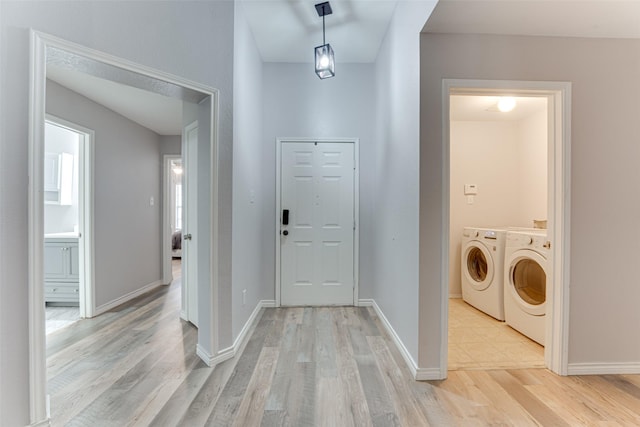 1900 Clear Creek Dr, Little Elm, TX 75068 - laundry area featuring washer and clothes dryer, light wood-type flooring, and baseboards