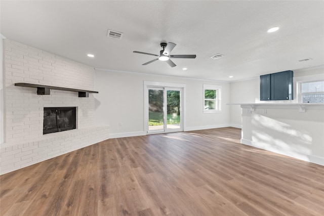 3408 Medallion Cir, Waco, TX 76706 - unfurnished living room featuring ceiling fan, a brick fireplace, wood finished floors, recessed lighting, and baseboards