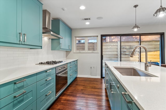 133 Lakeridge Dr, Dallas, TX 75218 - kitchen with appliances with stainless steel finishes, wall chimney exhaust hood, tasteful backsplash, dark wood finished floors, and light countertops