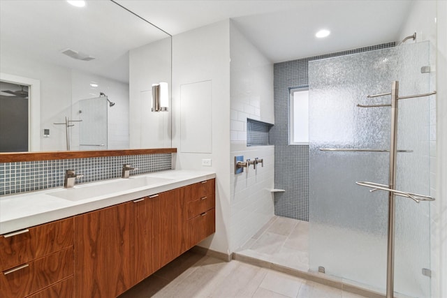 133 Lakeridge Dr, Dallas, TX 75218 - full bath featuring a tile shower, vanity, tile patterned floors, tasteful backsplash, and recessed lighting