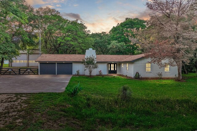 607 Audrey Ave, Waco, TX 76705 - ranch-style home with concrete driveway, a garage, and a chimney