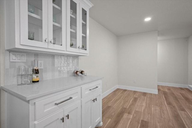 607 Audrey Ave, Waco, TX 76705 - bar with baseboards, light wood-type flooring, decorative backsplash, and recessed lighting