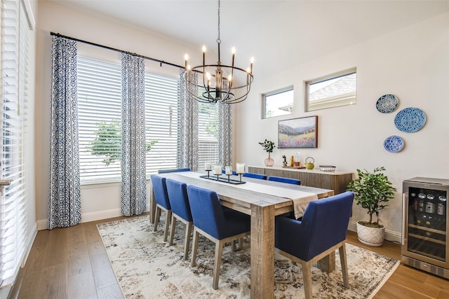 3717 Silver Birch Dr, Mckinney, TX 75071 - dining area with wine cooler, a chandelier, baseboards, and wood finished floors