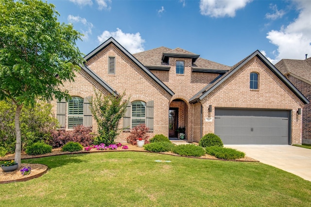 3717 Silver Birch Dr, Mckinney, TX 75071 - view of front of home with brick siding, driveway, a shingled roof, a front yard, and an attached garage