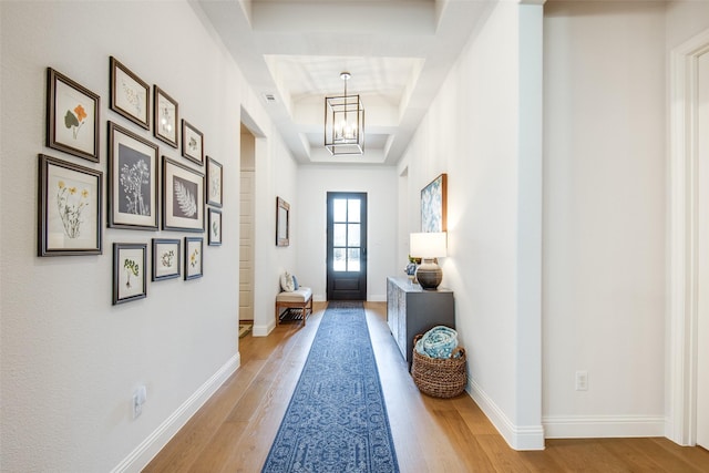 3717 Silver Birch Dr, Mckinney, TX 75071 - entryway with light wood-type flooring, a chandelier, a tray ceiling, and baseboards