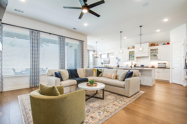 3717 Silver Birch Dr, Mckinney, TX 75071 - living area with ceiling fan, light wood-style floors, recessed lighting, baseboards, and a chandelier