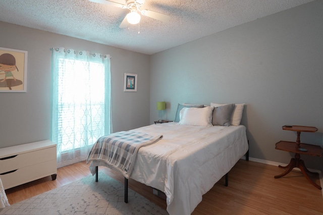 1903 Spies Springs Ct, Arlington, TX 76006 - bedroom featuring light wood-type flooring, a textured ceiling, baseboards, and ceiling fan