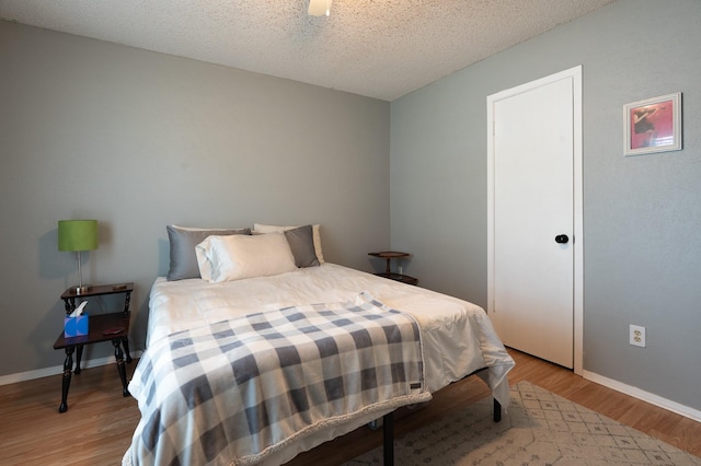 1903 Spies Springs Ct, Arlington, TX 76006 - bedroom featuring wood finished floors, baseboards, a textured ceiling, and ceiling fan