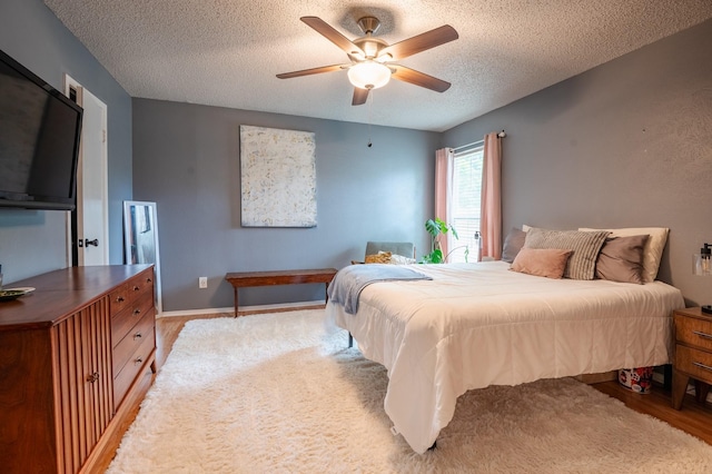 1903 Spies Springs Ct, Arlington, TX 76006 - bedroom with a textured ceiling, ceiling fan, and light wood-type flooring