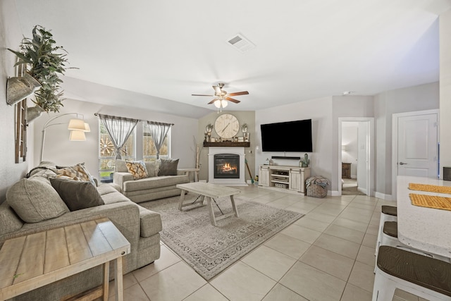 11013 Cobalt Dr, Aubrey, TX 76227 - living room featuring ceiling fan, light tile patterned floors, a glass covered fireplace, and baseboards