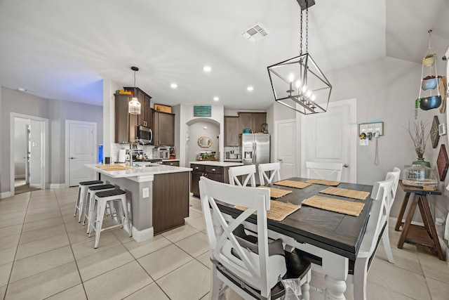 11013 Cobalt Dr, Aubrey, TX 76227 - dining area with light tile patterned floors, recessed lighting, baseboards, and a chandelier