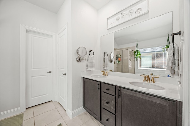 11013 Cobalt Dr, Aubrey, TX 76227 - bathroom with a stall shower, double vanity, tile patterned floors, and baseboards