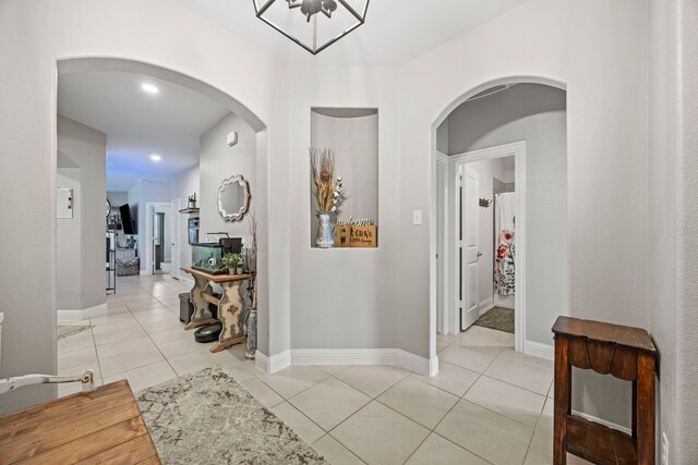 11013 Cobalt Dr, Aubrey, TX 76227 - corridor featuring arched walkways, light tile patterned floors, and baseboards