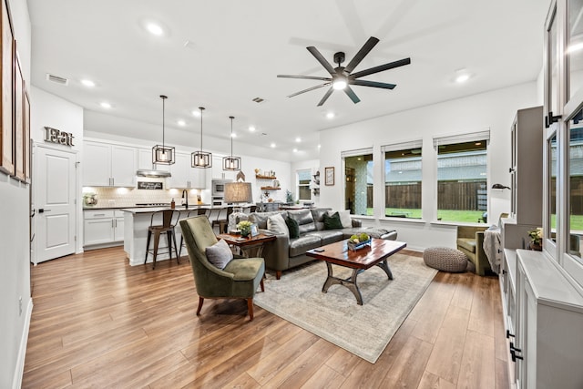 1224 Caprock Dr, Forney, TX 75126 - living room with recessed lighting, light wood-type flooring, plenty of natural light, and a ceiling fan