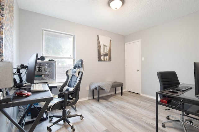 8713 Sabinas Trl, Fort Worth, TX 76118 - home office featuring light wood-type flooring, baseboards, and a textured ceiling
