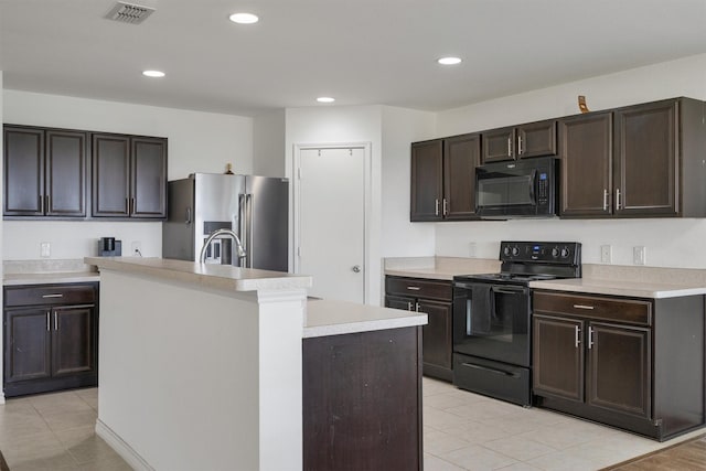 4506 Maplewood Ave, Balch Springs, TX 75180 - kitchen featuring black appliances, light countertops, light tile patterned flooring, a kitchen island with sink, and recessed lighting