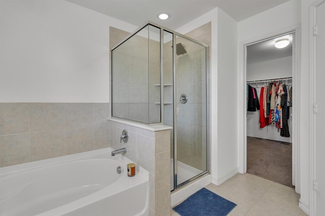 4506 Maplewood Ave, Balch Springs, TX 75180 - full bath featuring a stall shower, a bath, tile patterned flooring, a spacious closet, and baseboards