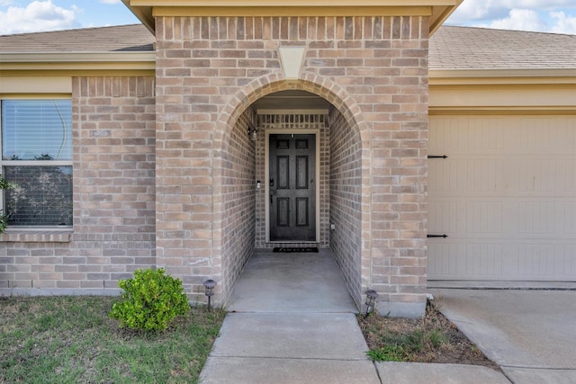 4506 Maplewood Ave, Balch Springs, TX 75180 - property entrance with brick siding, a garage, and roof with shingles