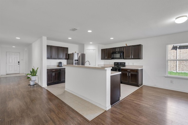 4506 Maplewood Ave, Balch Springs, TX 75180 - kitchen with black appliances, dark brown cabinets, light countertops, light wood finished floors, and recessed lighting