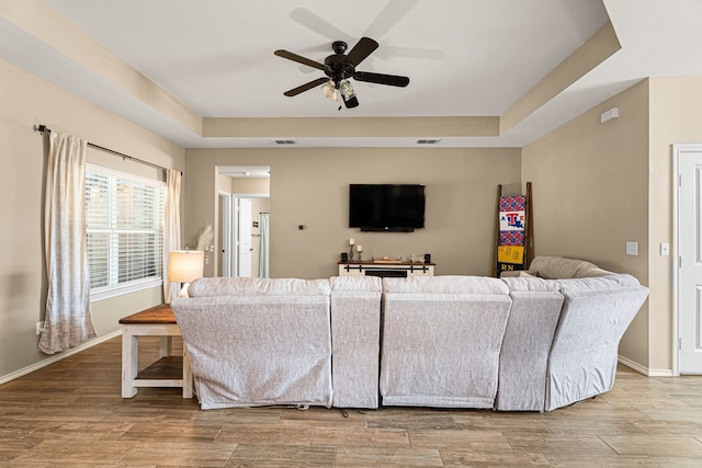 105 Mission Crest Cir, Lindale, TX 75771 - living area featuring a raised ceiling, a ceiling fan, wood finished floors, and baseboards